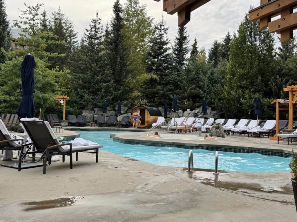 Swimming pool with sauna in the background of Four Seasons Whistler