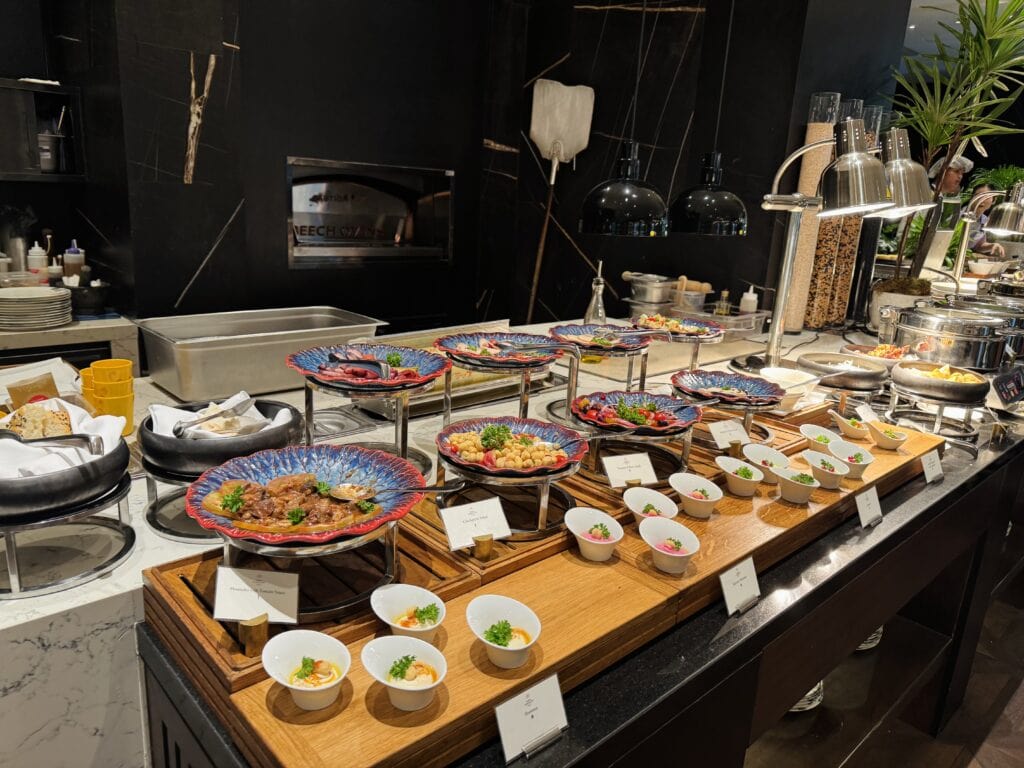 Luxurious breakfast buffet at Sindhorn Kempinski Bangkok with refined hot and cold dishes.