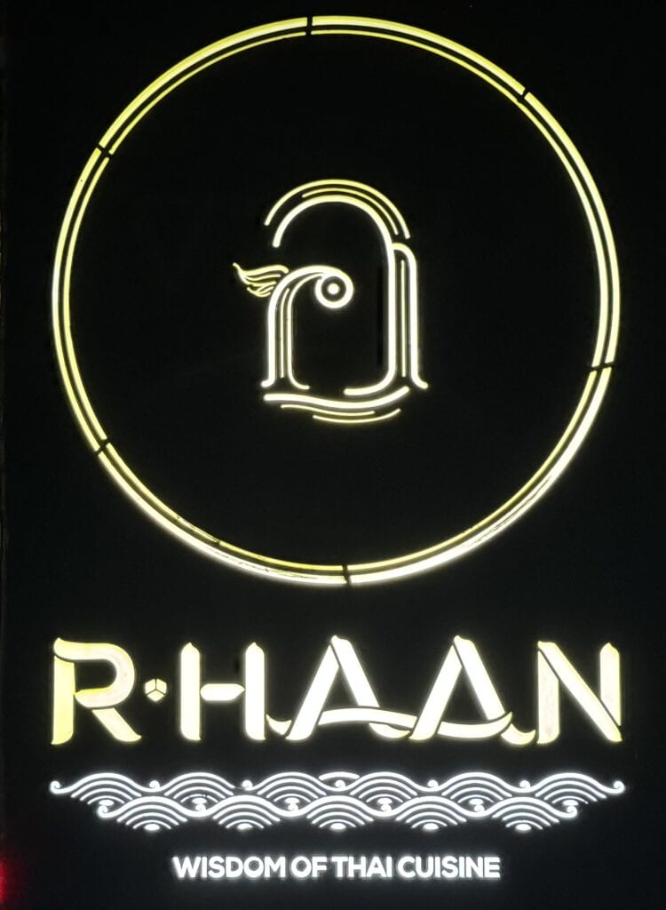 Neon logo sign of R-Haan, a Michelin-starred Thai fine dining restaurant in Bangkok.
