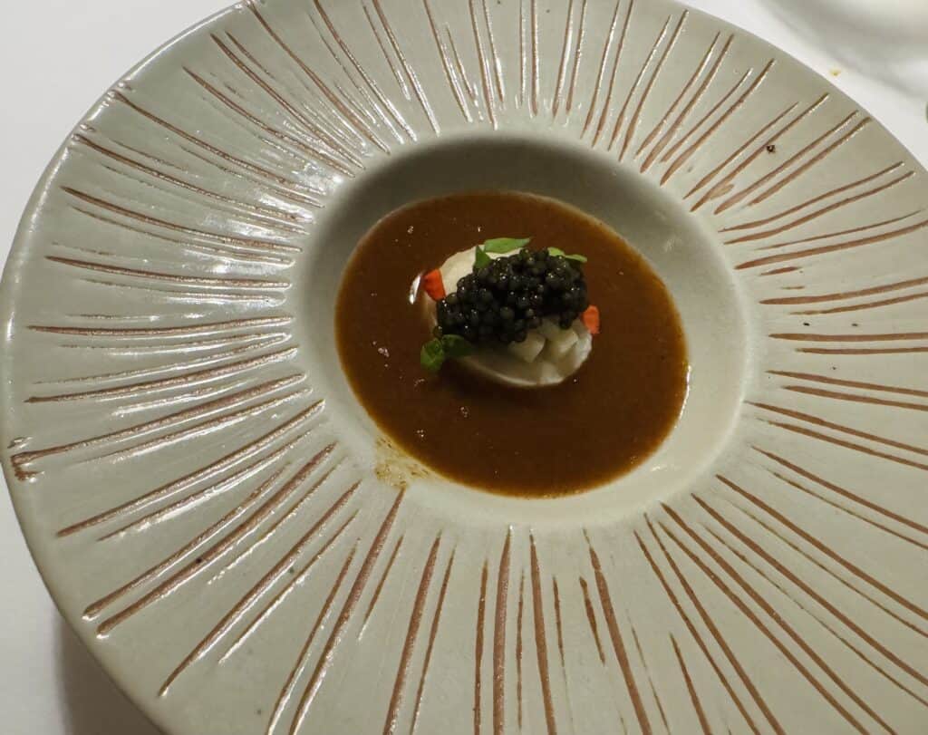 Cauliflower mousse with caviar in spicy Gaeng Som soup, a classic from the chef at R-Haan.