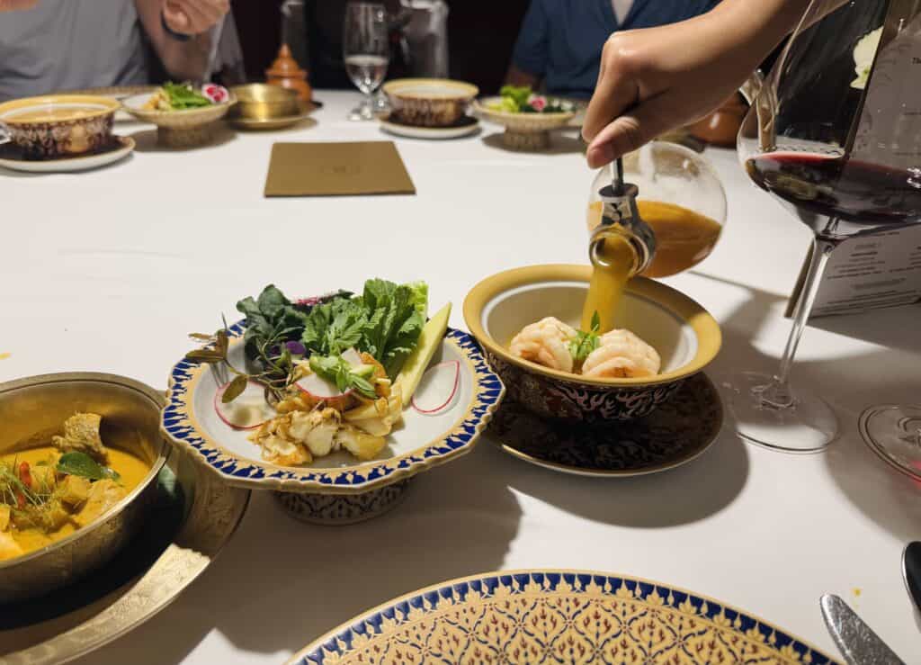 Tom Yum soup served at the table with shrimp and Thai herbs at R-Haan.