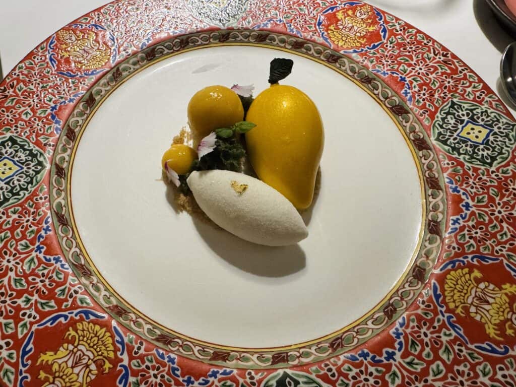 Mango sticky rice dessert on a colorful traditional Thai plate at R-Haan.