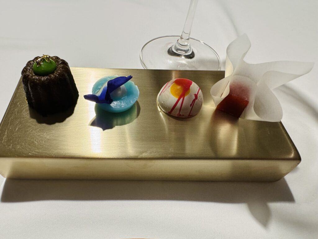 Selection of friandises at R-Haan, served on a golden platter.