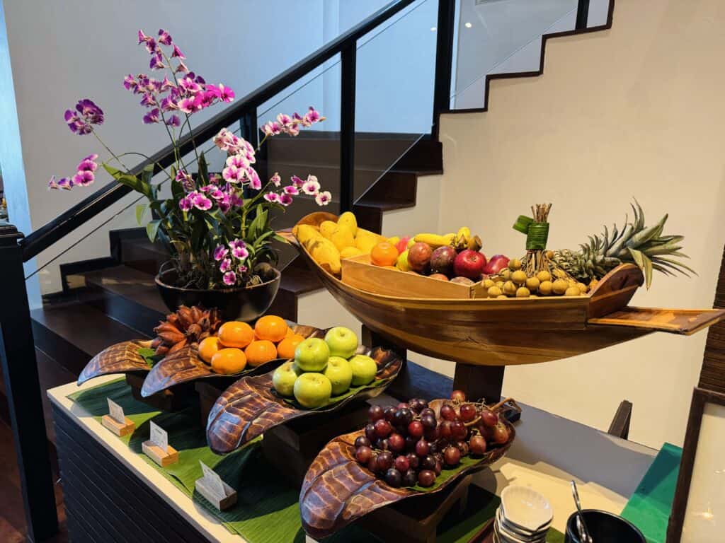 Fruit presentation with orchids and a wooden Thai fruit boat during breakfast at Phulay Bay.