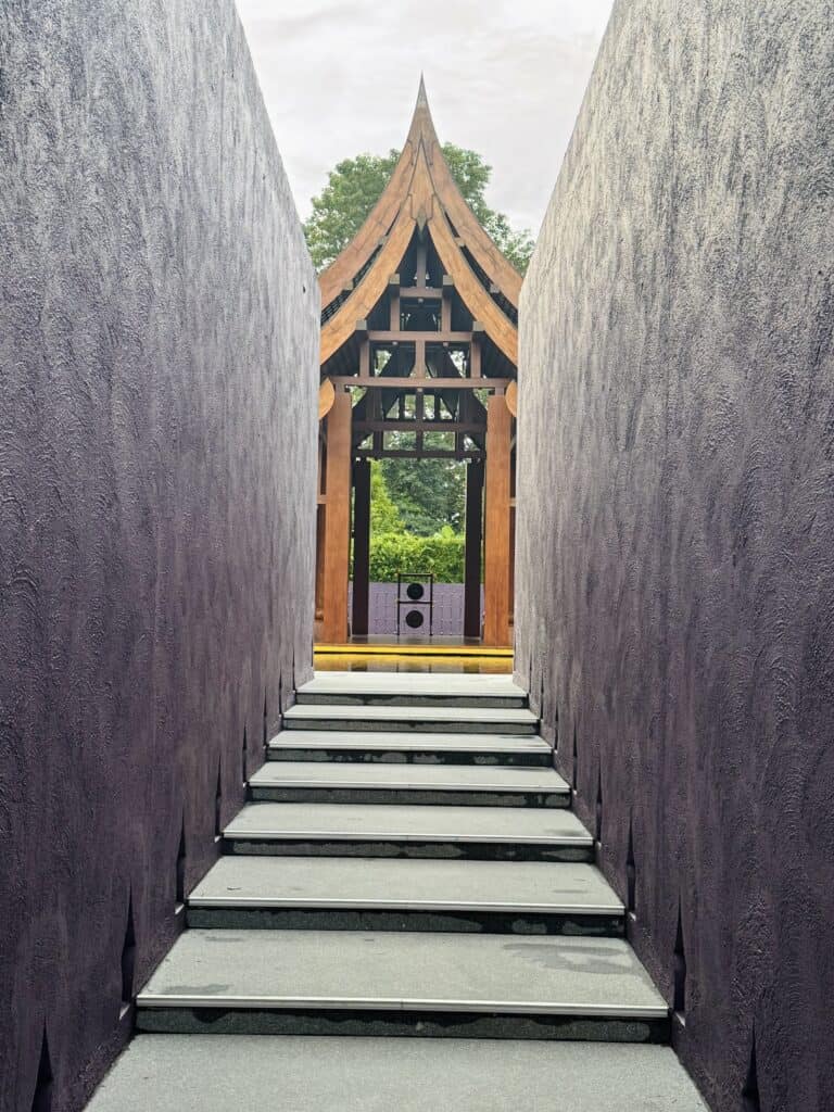 Purple-walled staircase leading to the wooden pavilion at Phulay Bay in Krabi.