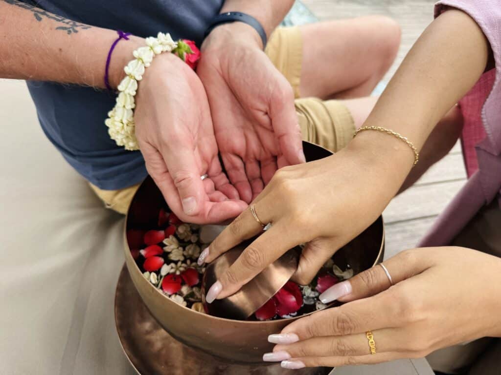 Traditional arrival ceremony with flower ritual at Anantara Mai Khao Phuket Villas in Thailand