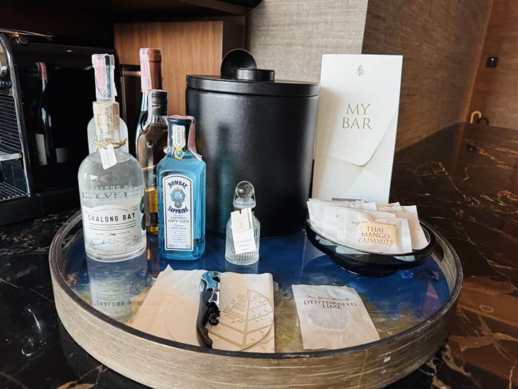 Luxury minibar with premium gin and exclusive amenities in a hotel suite in Bangkok